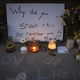 Some candles were lit as darkness fell Monday at the sidewalk kmemorial to Justine Damond, the Australian woman slain by a Minneapolis policeman. (Jeff Wheeler /Star Tribune)
